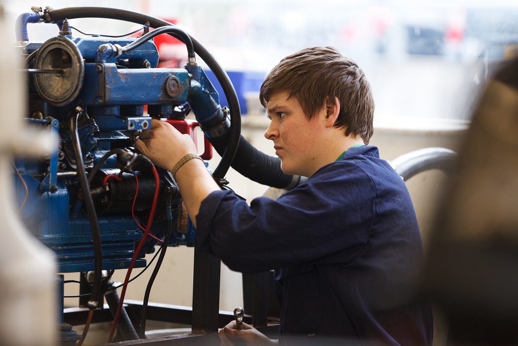 Student fixing a marine Engine